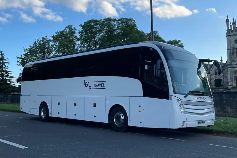 Leap Travel 48-seat Levante executive coach parked by a church