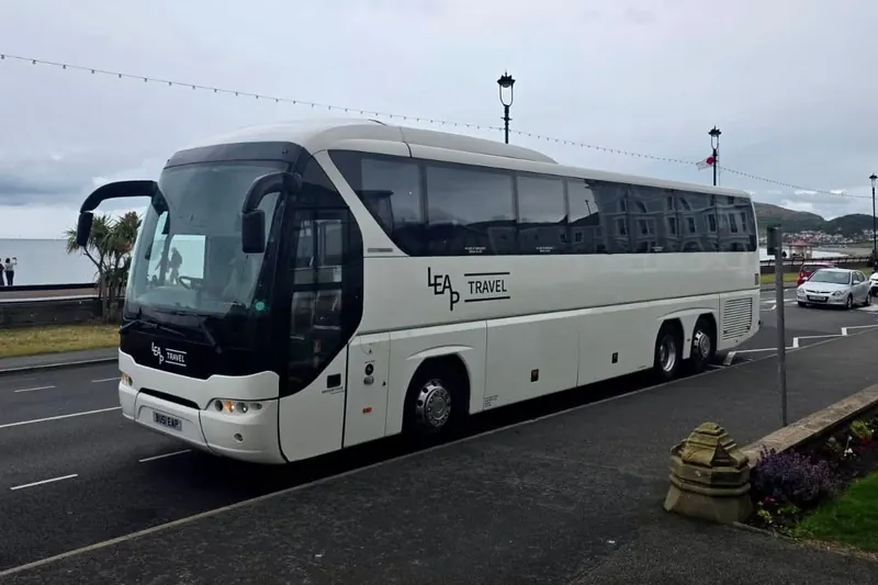 Leap Travel 55-seat Tourliner coach on Llandudno promenade