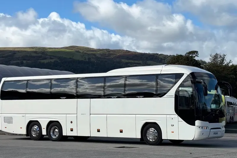 Leap Travel 55-seat Tourliner coach with hills behind