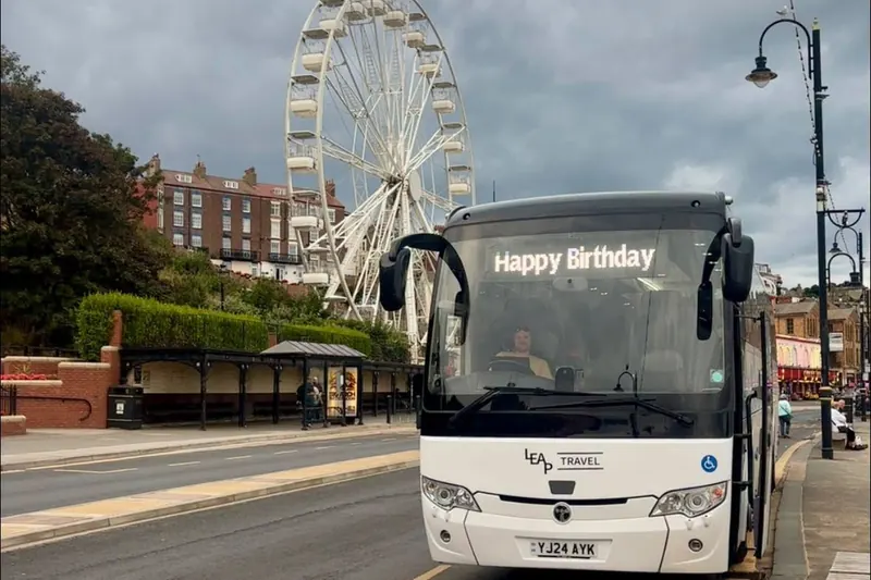 Leap Travel Temsa coach with a Happy Birthday sign