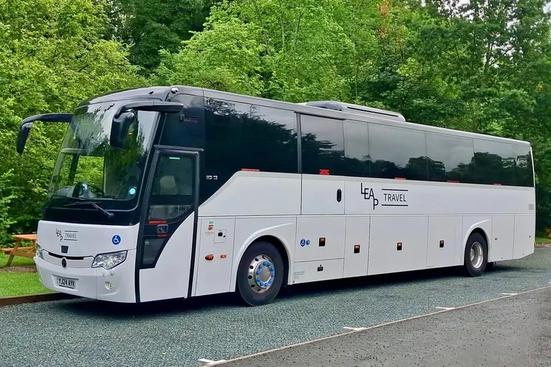 Leap Travel 57-seat Temsa coach surrounded by trees