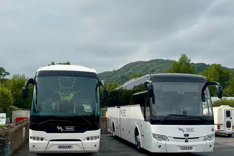 Two Leap Travel coaches parked by Lake Windermere